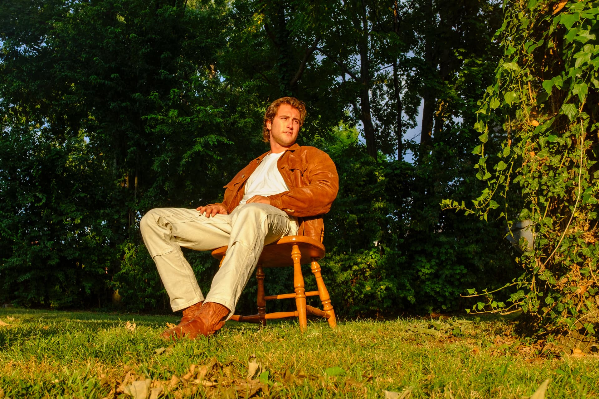 Dante DeRosa seated on a wooden chair in the garden